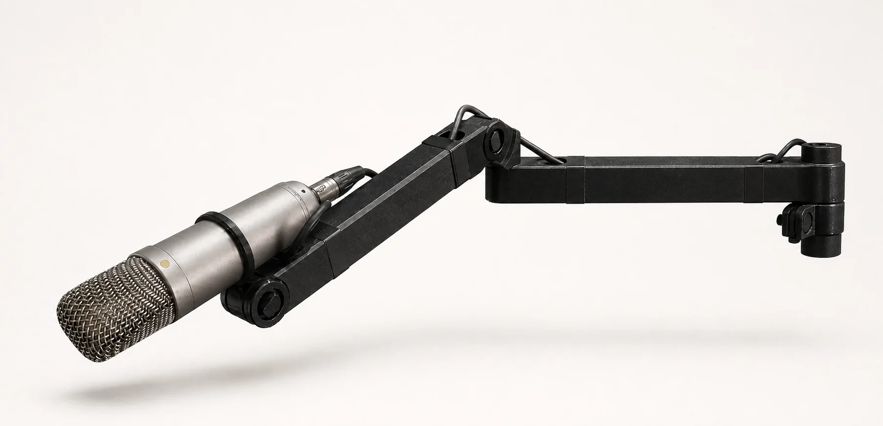 Microphone argenté monté sur un support noir articulé imprimé en 3D